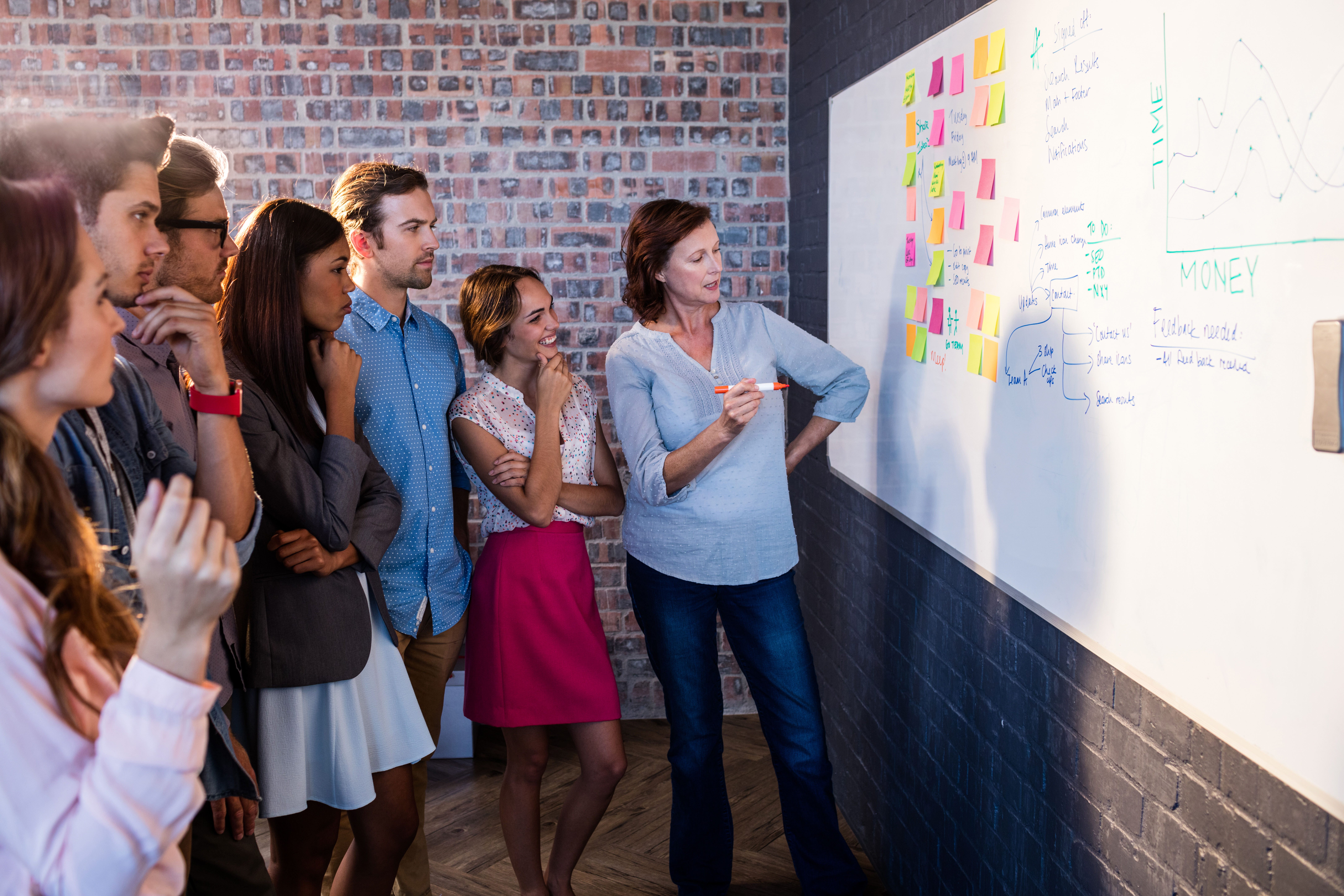 Coworkers analyzing a board