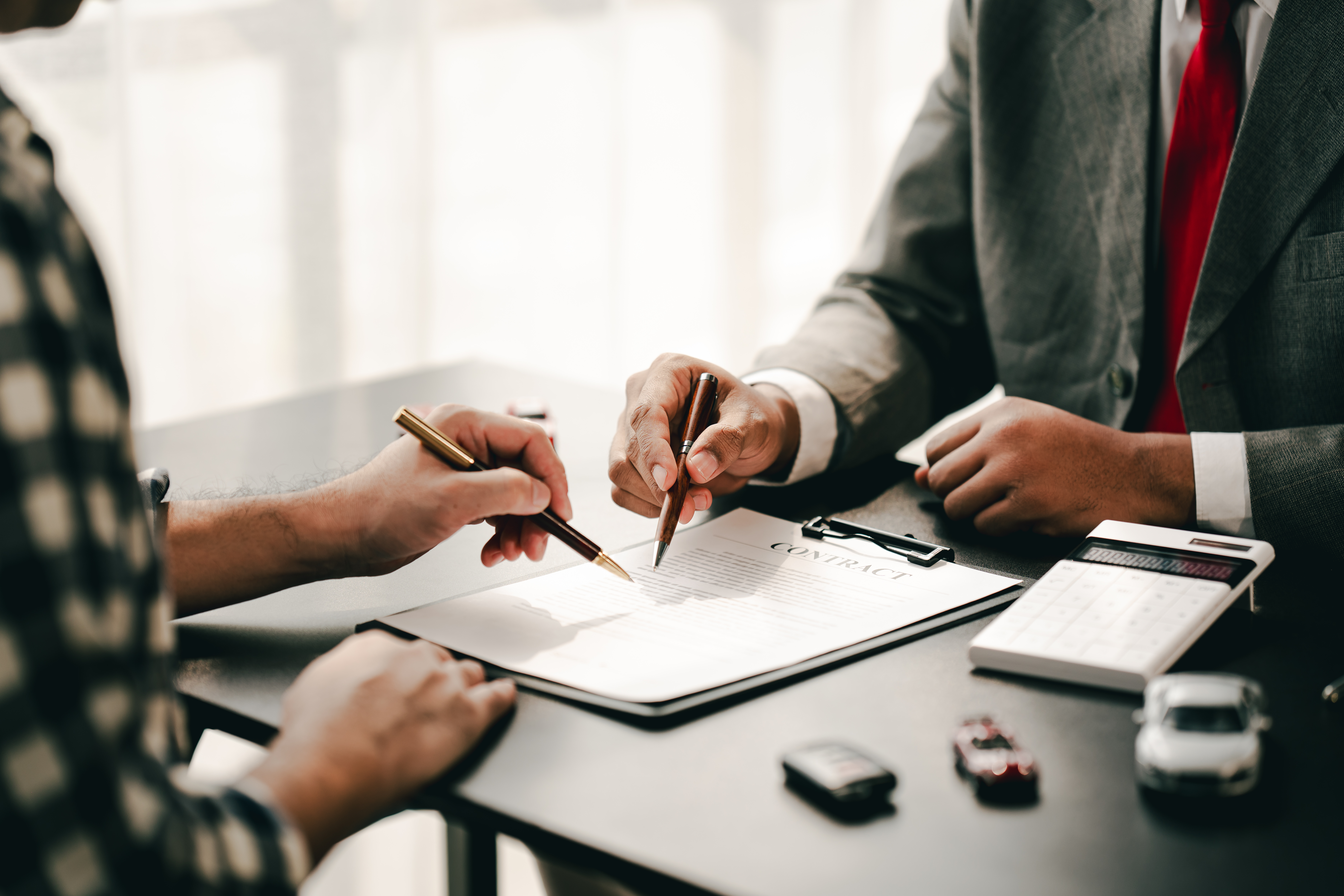Two men reviewing and signing a contract