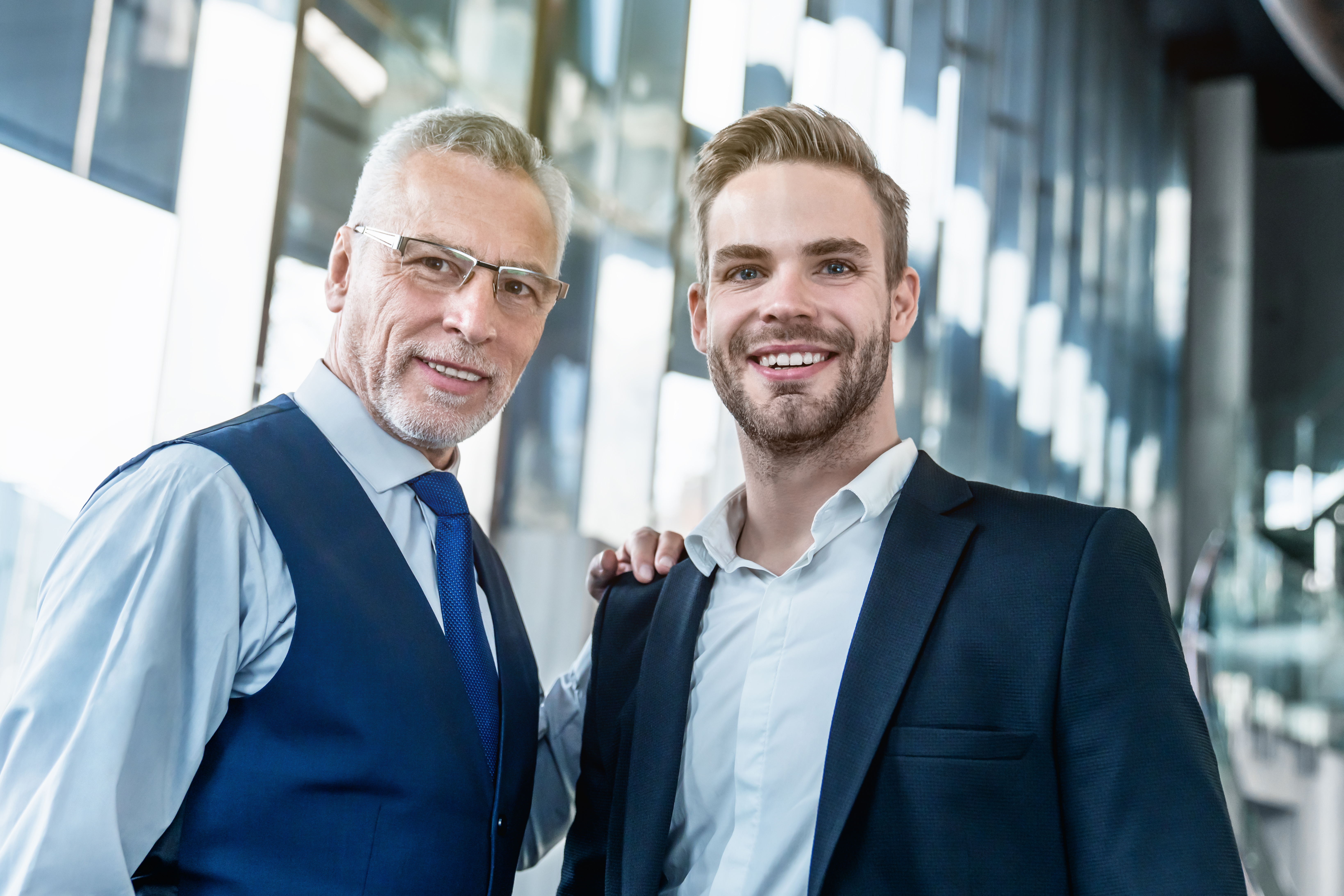 Two business men standing together