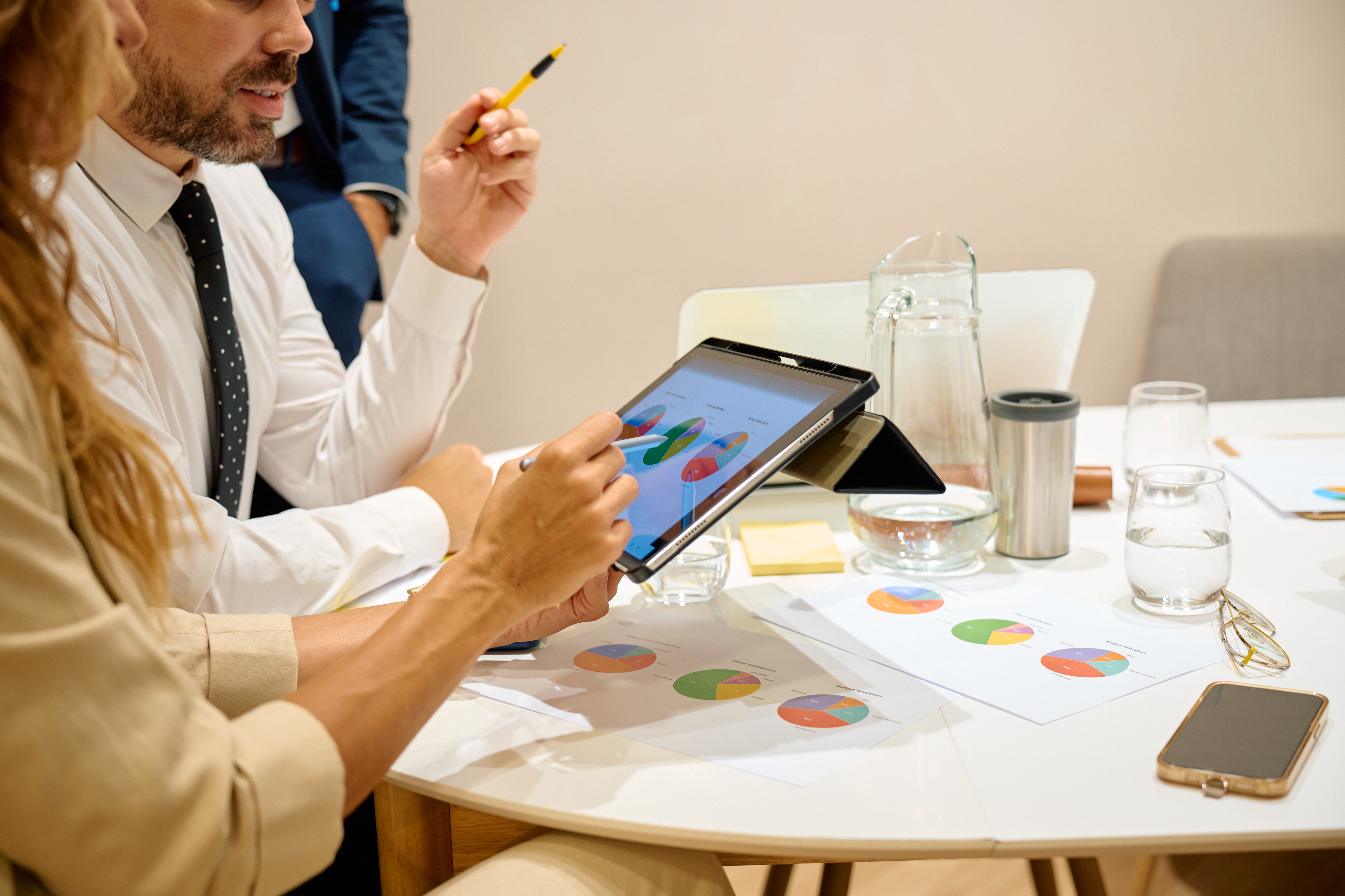 Business professionals discussing pie chart data
