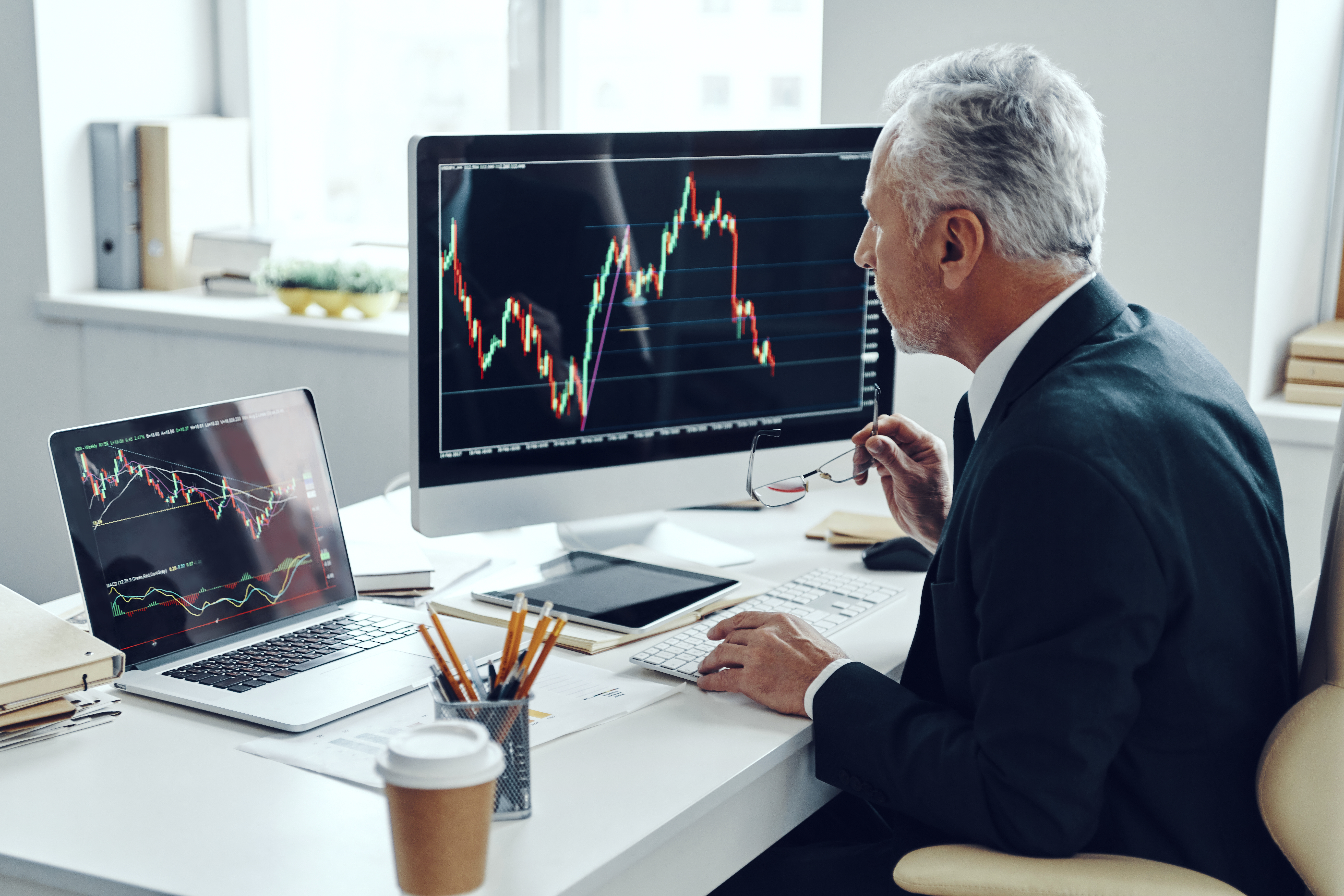 Senior trader using computer
