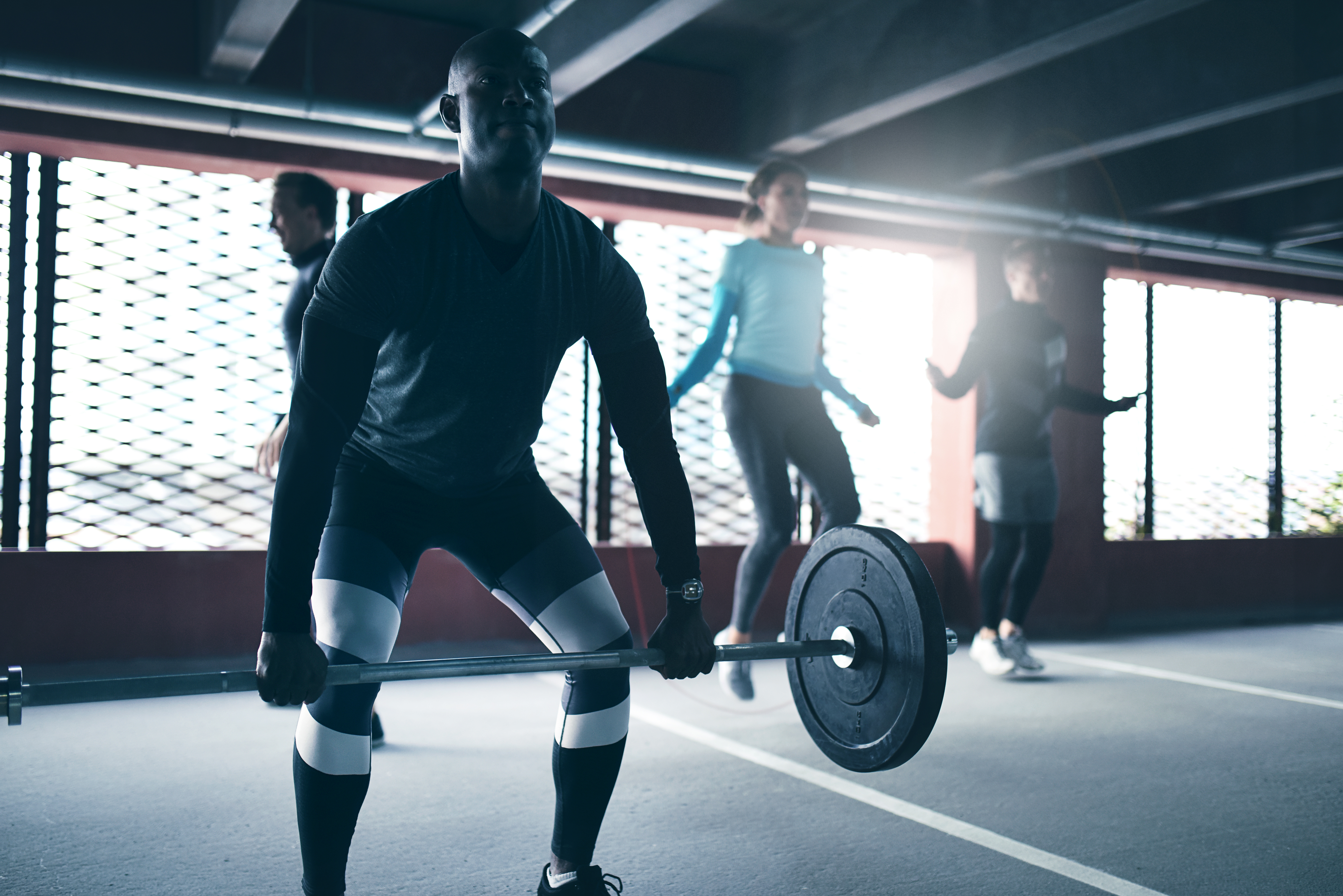 Determined man lifting weights