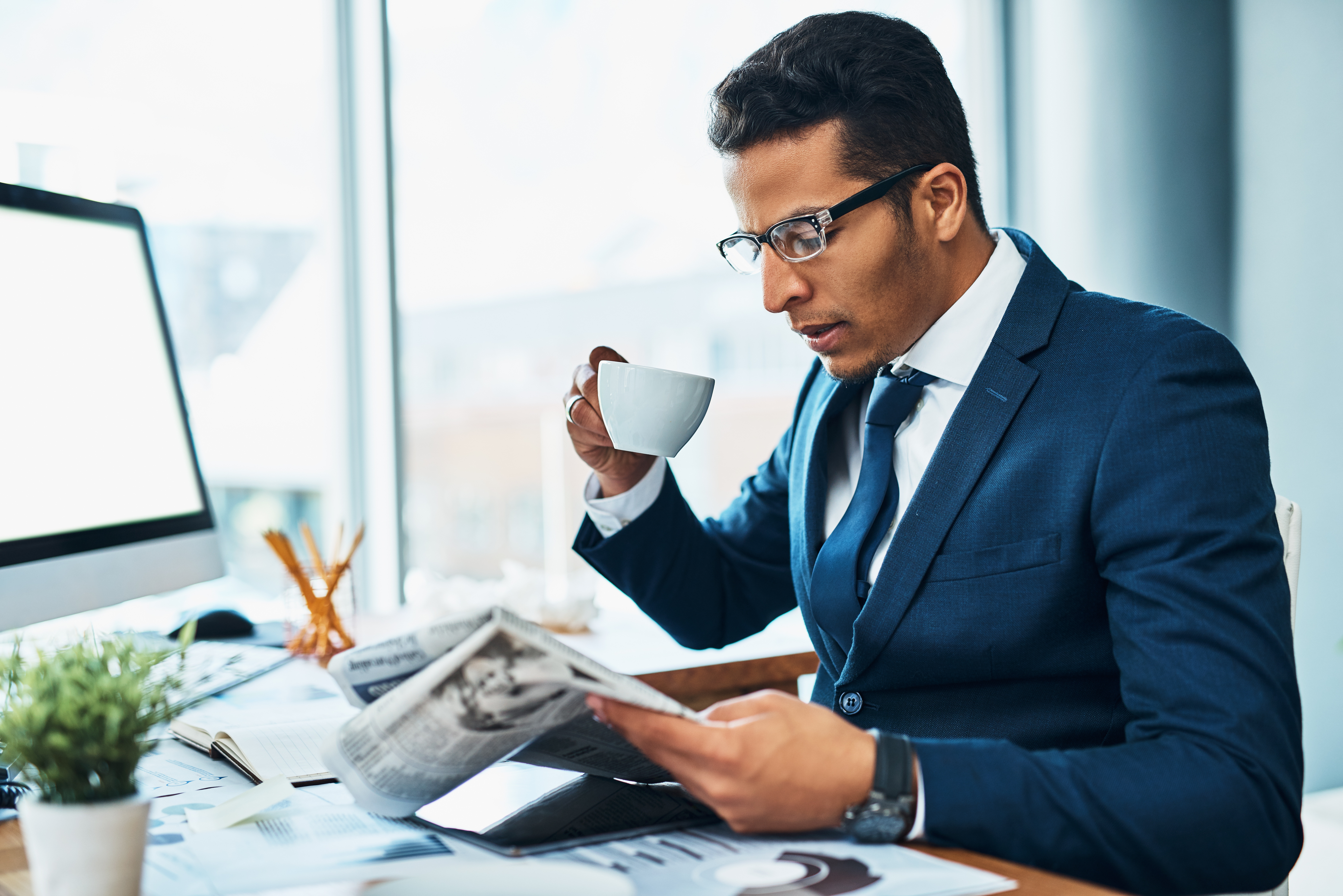 Professional man reading newspaper